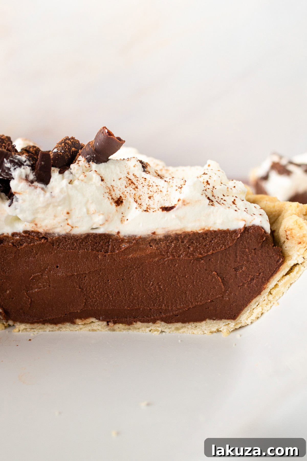 Overhead shot of a full Chocolate Cream Pie, beautifully garnished with chocolate shavings and whipped cream.
