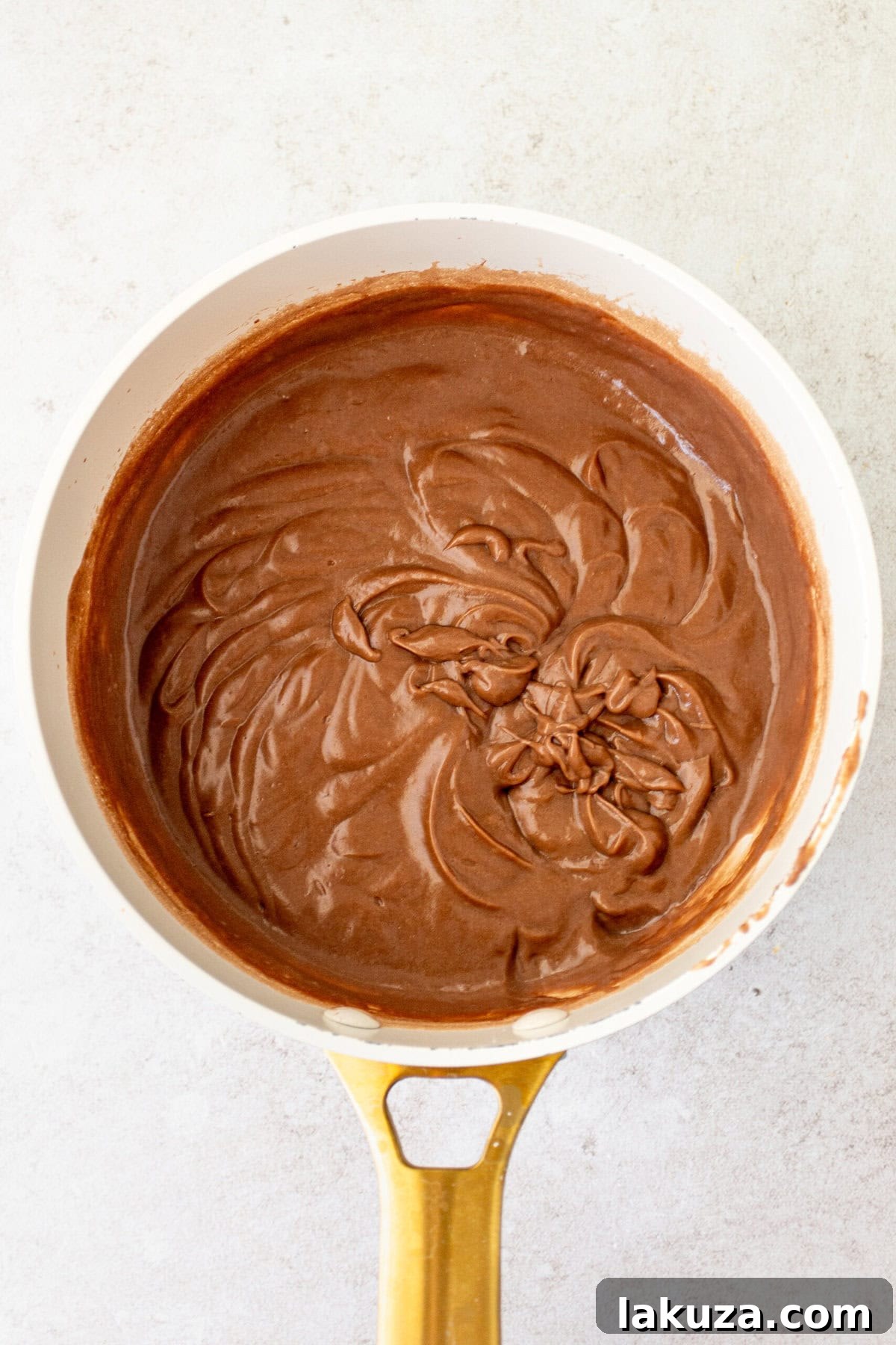 Chocolate Cream Pie filling thickening in a saucepan, showing its rich, dark color.