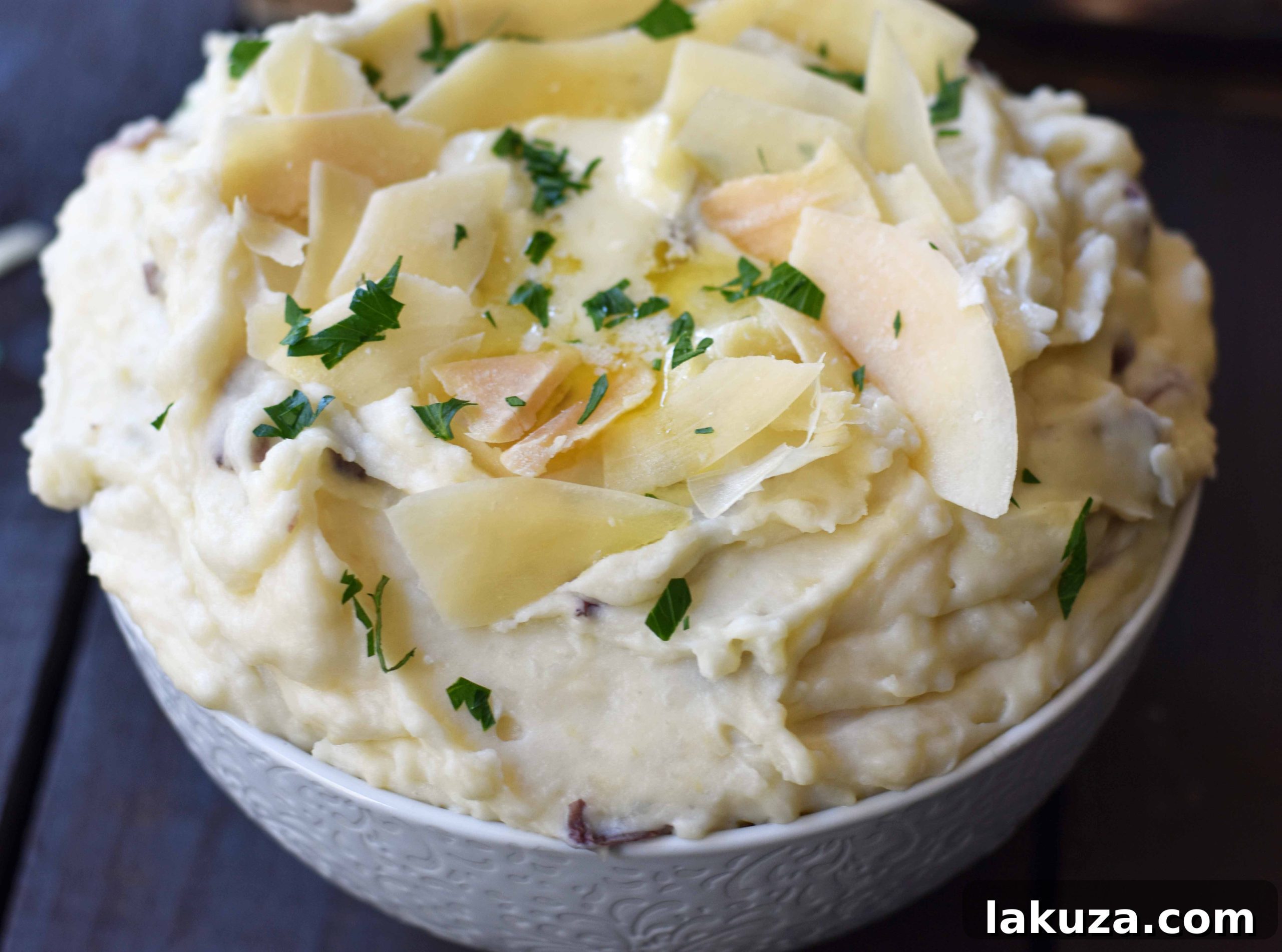 Creamy Parmesan Mashed Potatoes are the perfect mashed potatoes. Rich and creamy potatoes with butter, half-n-half, sour cream, and parmesan cheese. The most flavorful and creamy mashed potatoes! A popular side dish. www.modernhoney.com