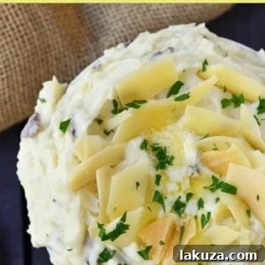 Creamy Parmesan Mashed Potatoes are the perfect mashed potatoes. Rich and creamy potatoes with butter, half-n-half, sour cream, and parmesan cheese. The most flavorful and creamy mashed potatoes! A popular side dish. www.modernhoney.com