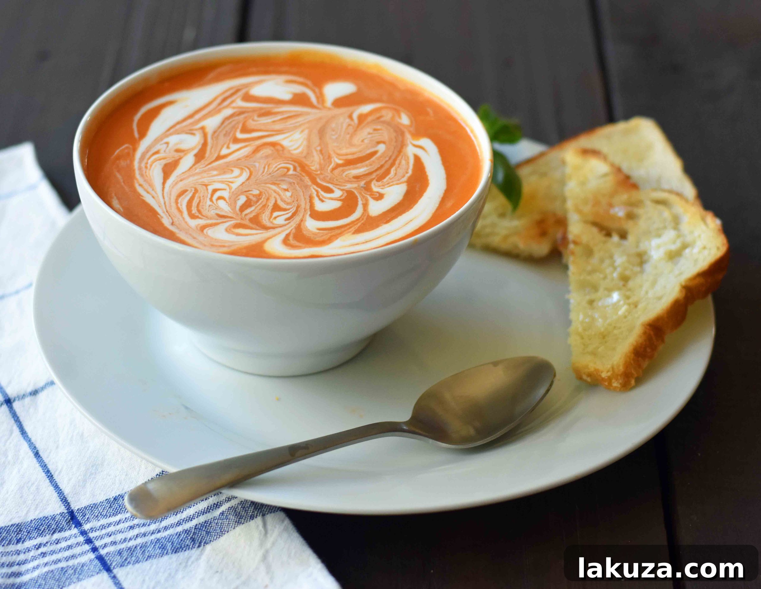 The best creamy tomato basil soup recipe, showcasing its smooth texture and vibrant color. Made from scratch with fresh ingredients, this comforting soup is a game-changer for tomato soup lovers. Pair it with a gourmet grilled cheese for an unforgettable meal.