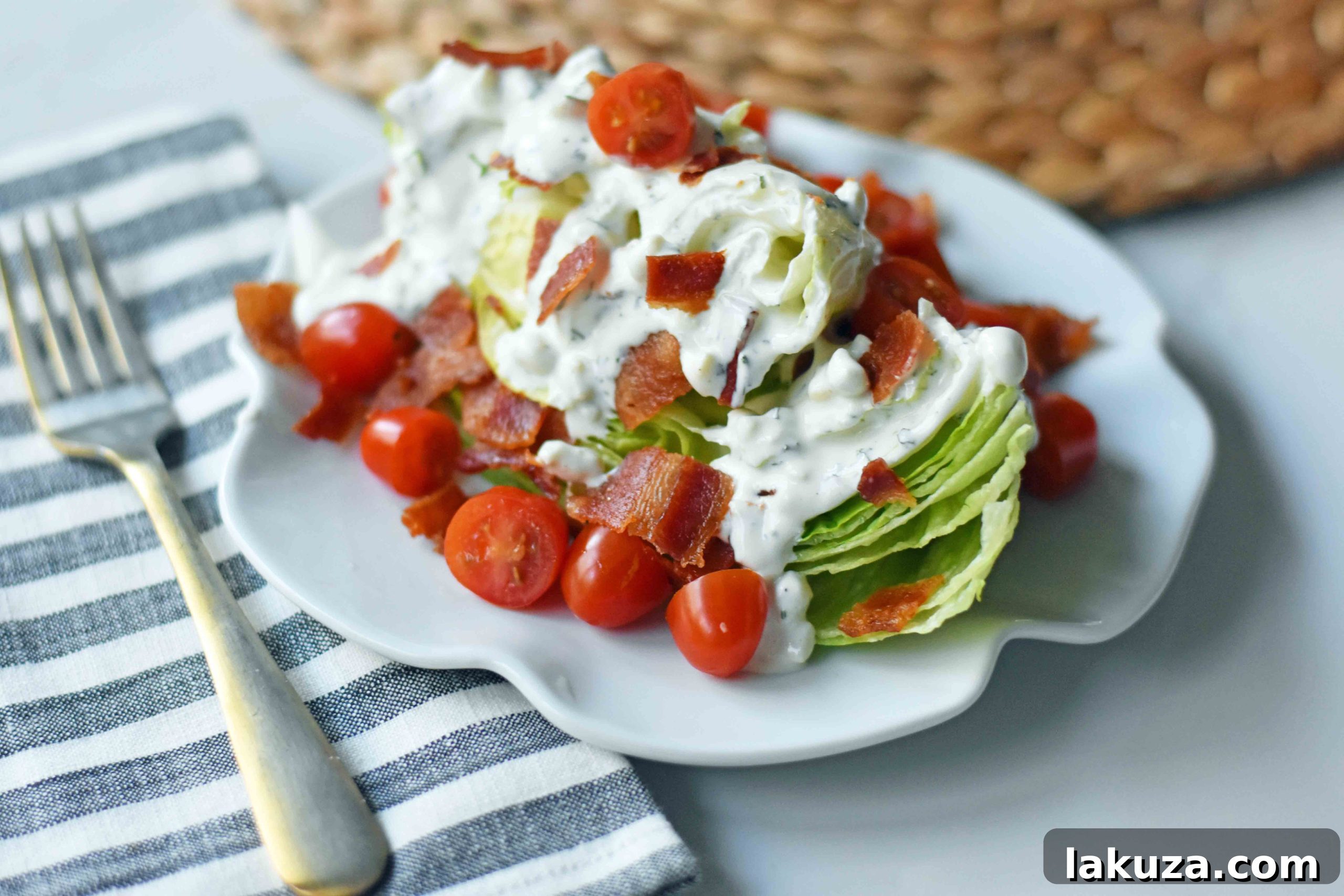 Iconic BLT Wedge 5 The Ultimate BLT Wedge Salad, perfectly plated and ready to serve, featuring crisp iceberg, bacon, tomatoes, and creamy dressing.