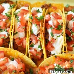 Easy Oven Baked Beef Tacos with all the fixings, ready to serve.