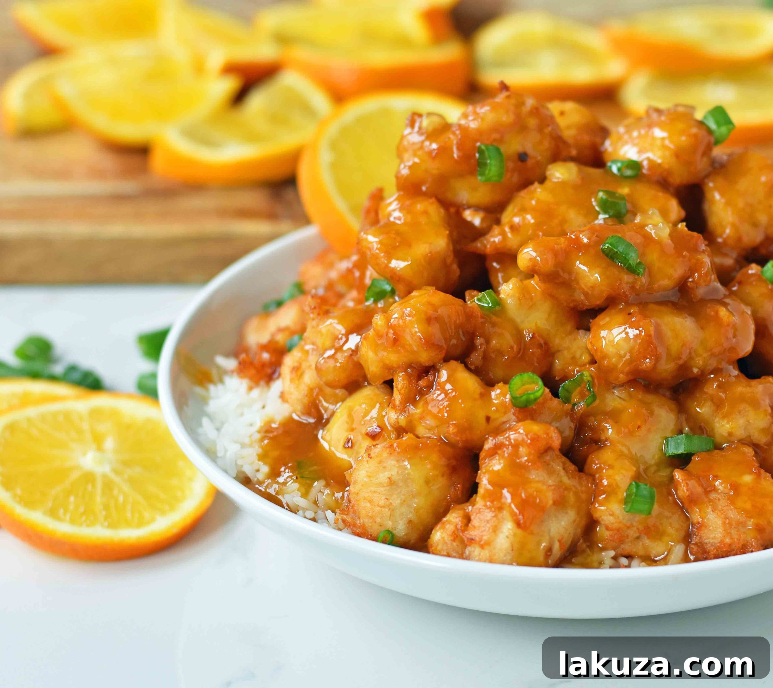 Close-up of golden brown, crispy fried chicken pieces before being tossed in orange sauce.