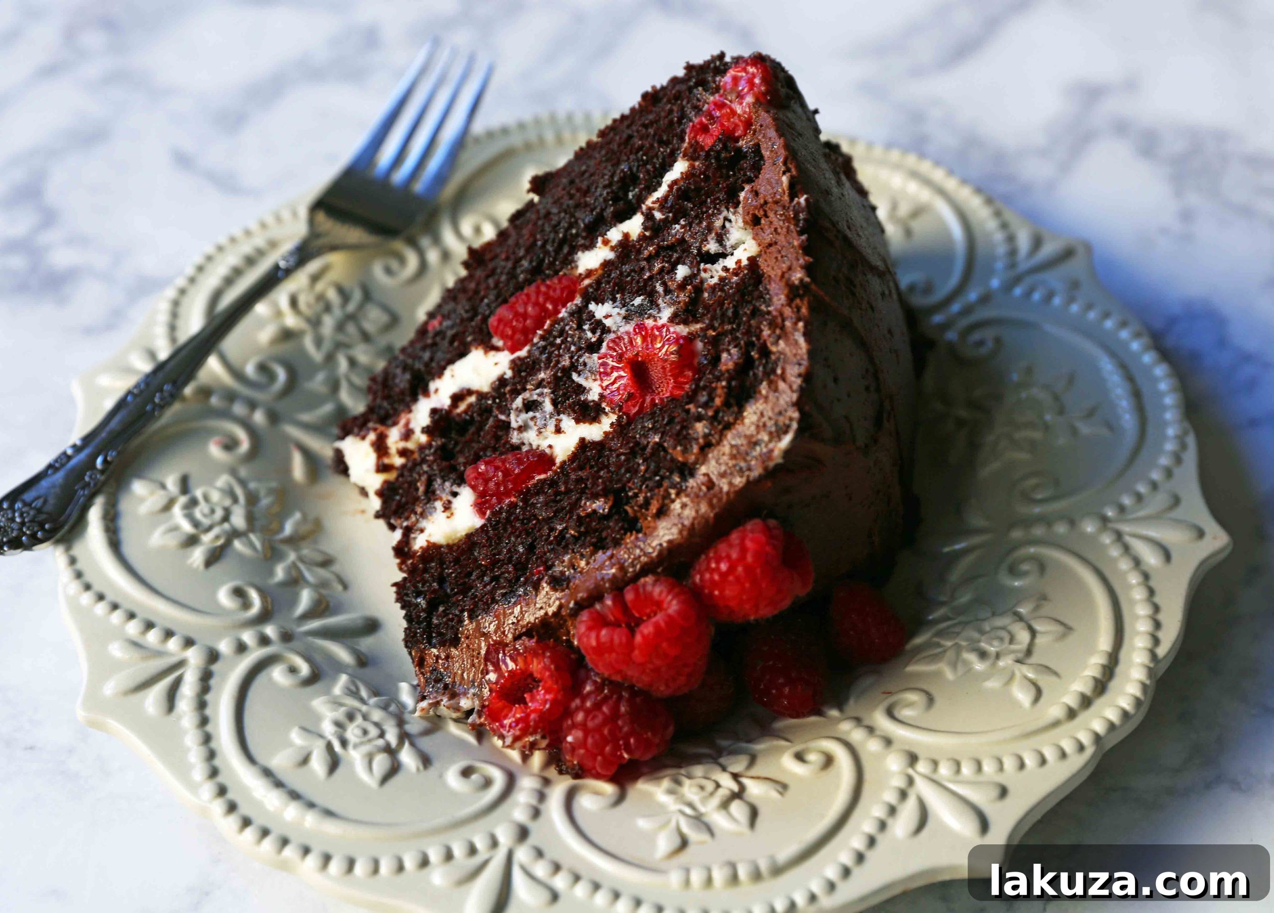 Decadent Chocolate Raspberry Delight 4 A beautifully frosted Chocolate Raspberry Cake adorned with fresh raspberries.