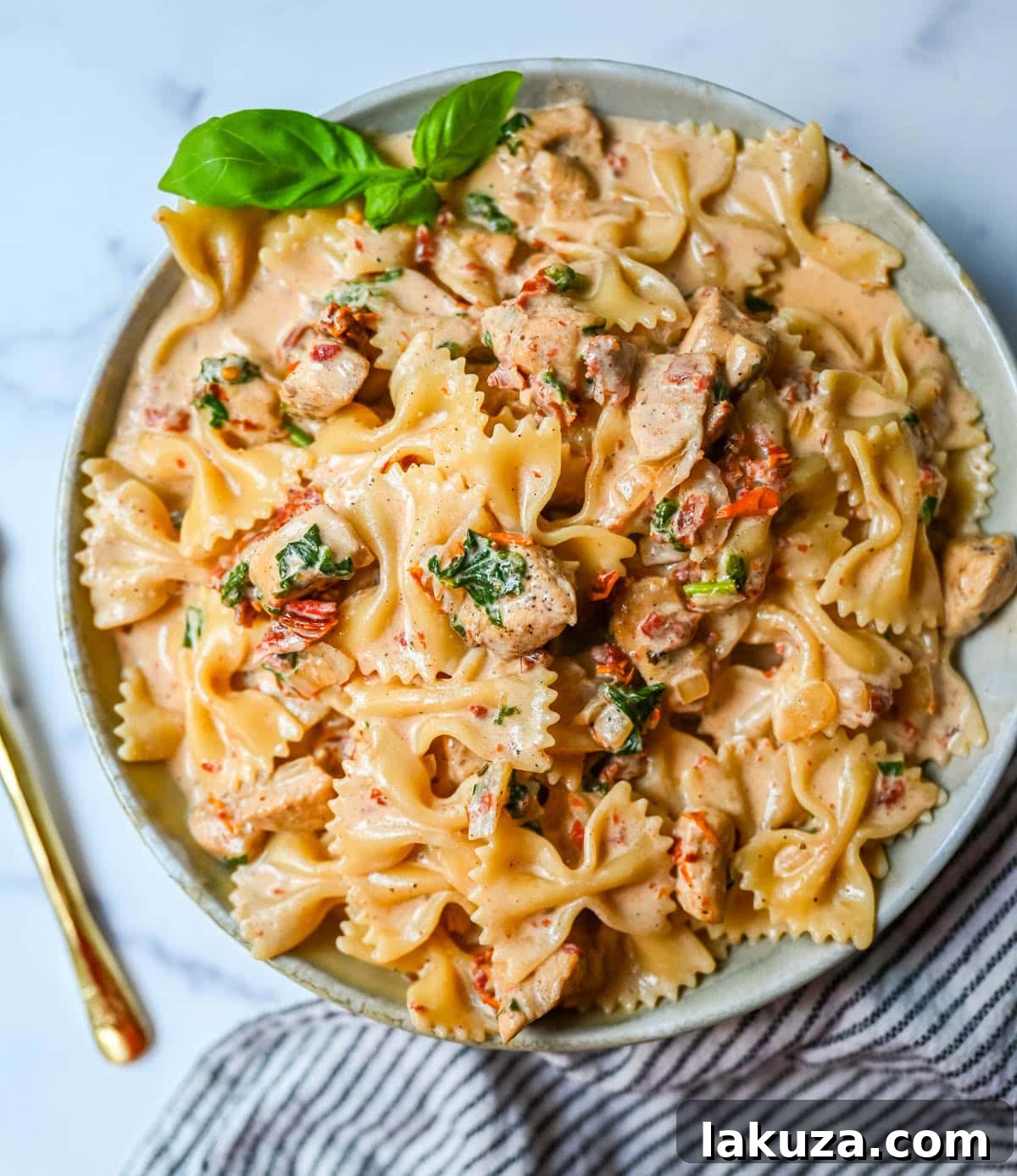 Close-up shot of Marry Me Chicken Pasta showing the rich, creamy texture and generous chunks of chicken.