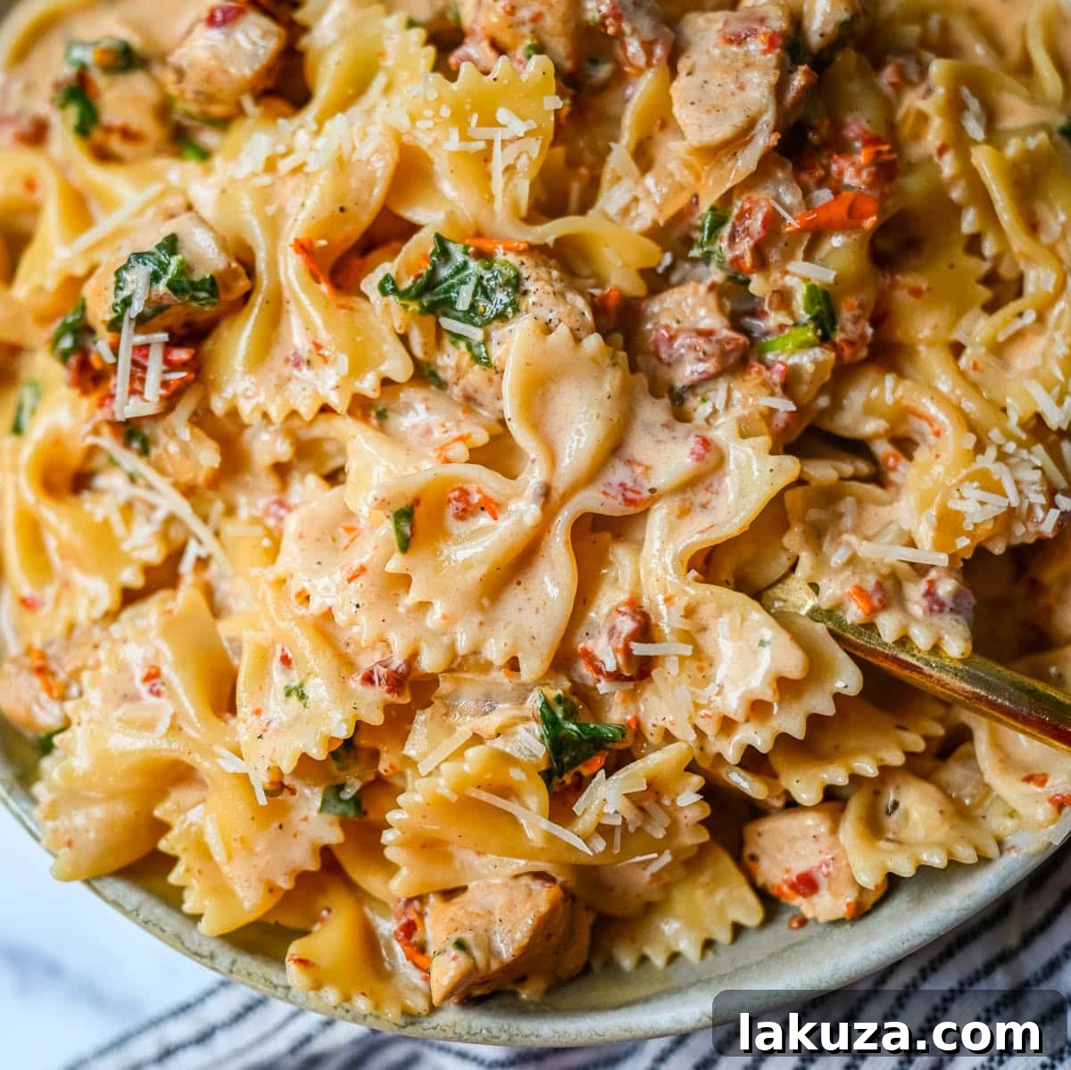 A top-down view of the creamy Marry Me Chicken Pasta garnished with fresh basil, ready to be served.