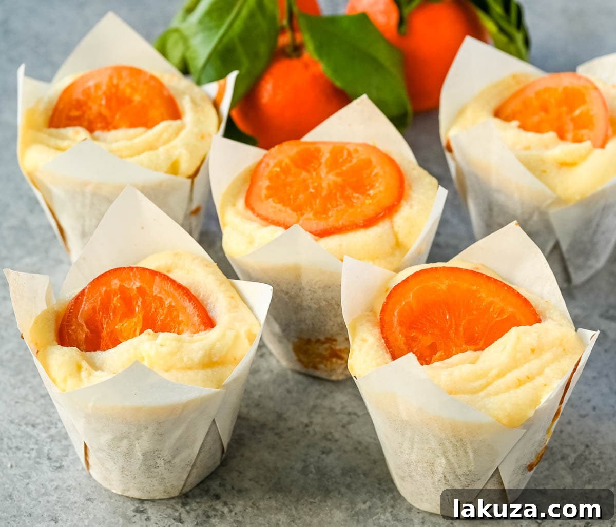 Sun-Kissed Orange Olive Oil Delights 5 A tray of freshly baked moist orange olive oil cupcakes with delicate swirls of orange cream cheese frosting.