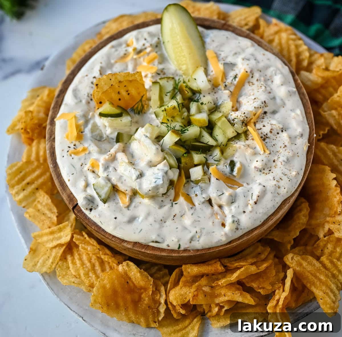 Tangy Dill Delight 3 Close-up of vibrant dill pickle dip garnished with fresh dill and chopped pickles.