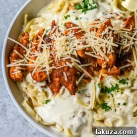 Cajun Chicken Alfredo with tender blackened chicken and a silky Parmesan cream sauce over pasta.