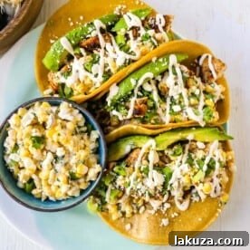 Mexican Street Corn Chicken Tacos with marinated grilled chicken, homemade street corn salsa, and spiced crema.