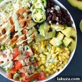 Healthy Grilled Chicken Burrito Bowls, a Chipotle copycat with chili lime chicken, pico de gallo, avocado, and cilantro ranch.