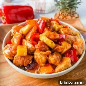 Crispy Sweet and Sour Chicken covered in a pineapple sweet and sour sauce, better than takeout.