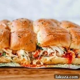 Baked Chicken Parm Sliders with marinara, mozzarella, and garlic butter on Hawaiian sweet rolls.