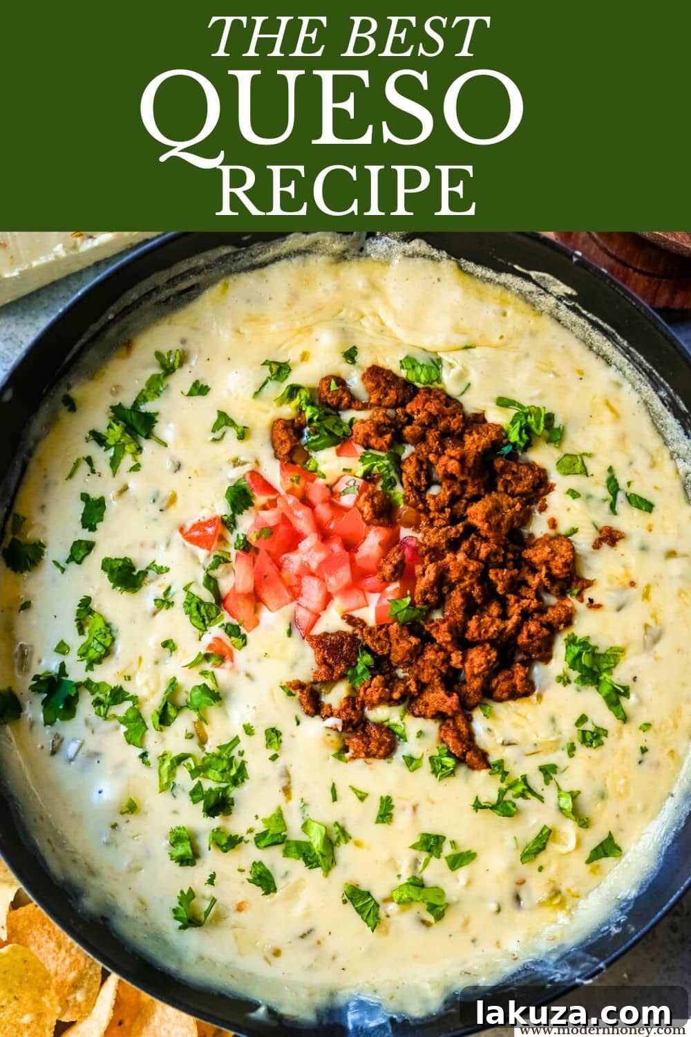 Ultimate Creamy Queso Dip 8 A large serving bowl filled with creamy white queso dip, ready for a party, with a spoon for serving.