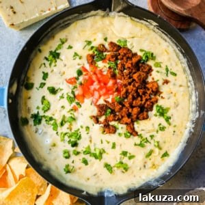 Ultimate Creamy Queso Dip 9 A serving of the best creamy white queso dip with fresh toppings.
