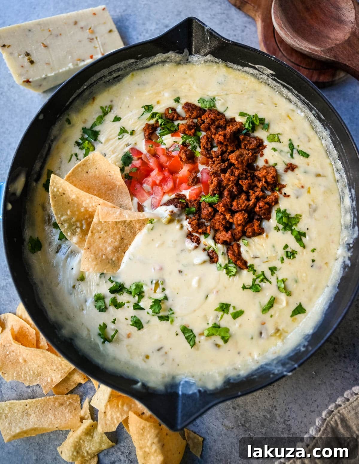 Ultimate Creamy Queso Dip 6 Ingredients for making white queso, including blocks of cheese, evaporated milk, and canned green chiles.