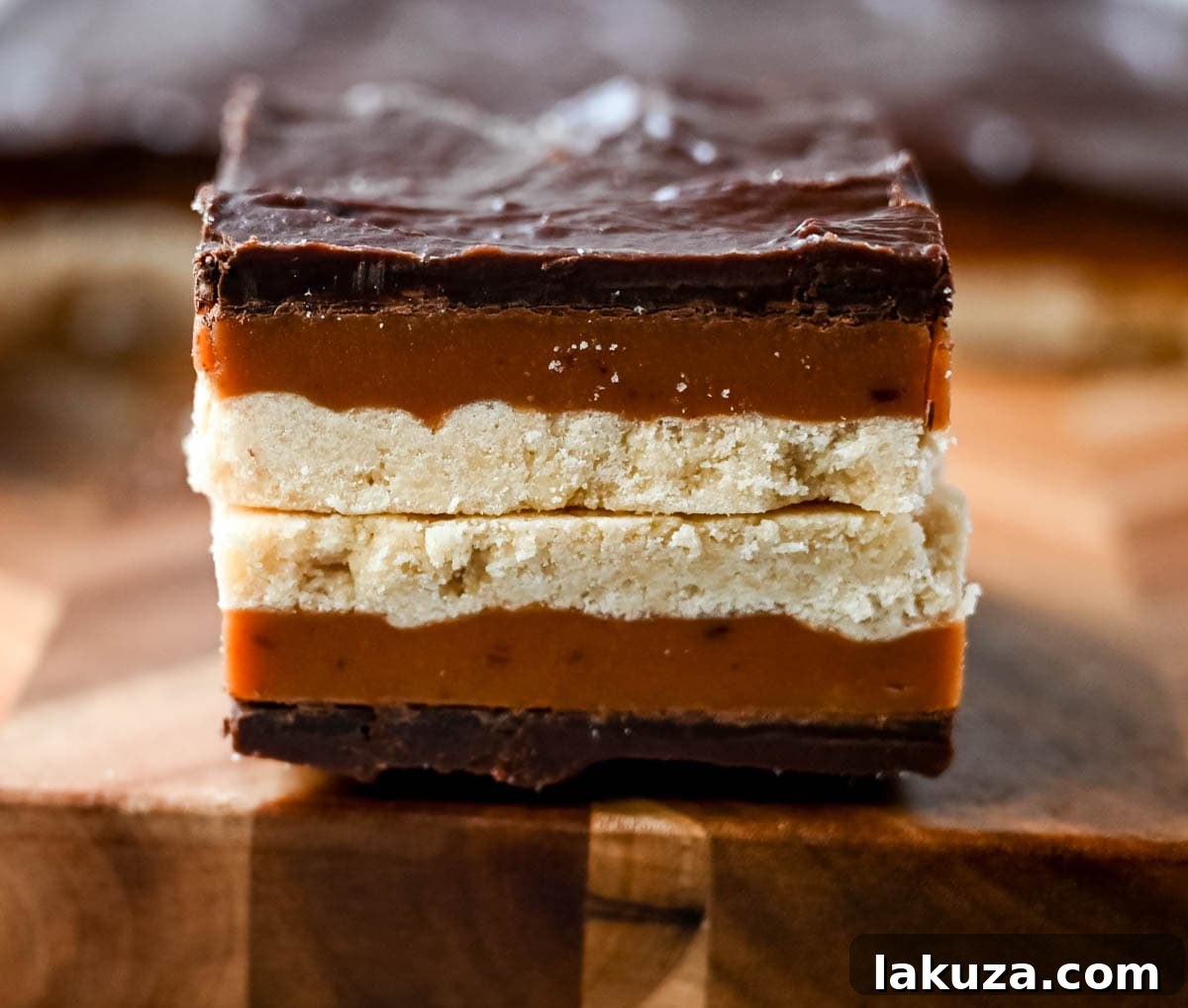 Decadent Millionaire Bars 7 Beautifully arranged Millionaire Bars on a platter, ready to be served as a delightful dessert.