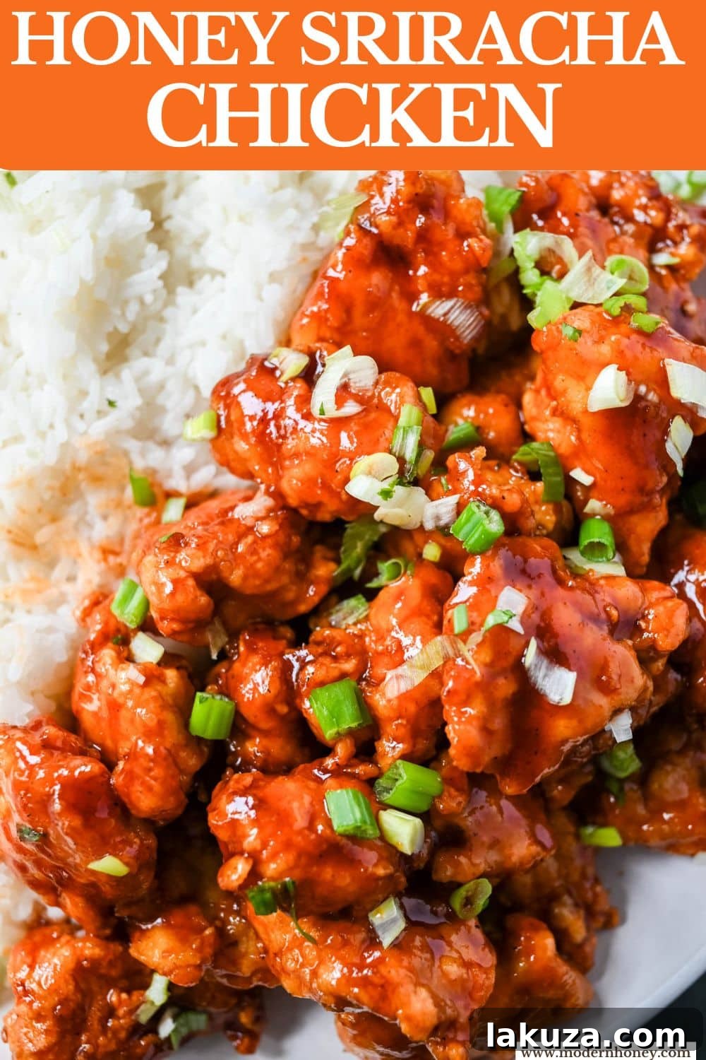 Sticky Honey Sriracha Chicken 7 A beautifully plated dish of Honey Sriracha Chicken, garnished with green onions and sesame seeds, ready to be enjoyed.