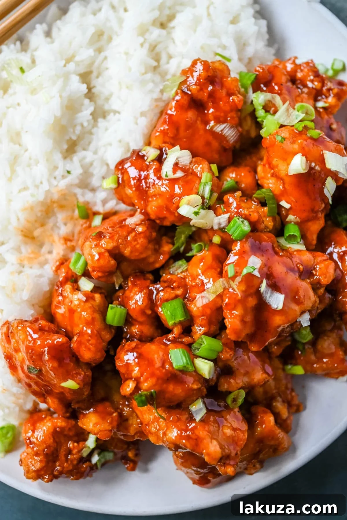 Sticky Honey Sriracha Chicken 4 A selection of fresh ingredients laid out, including chicken breast, eggs, flour, cornstarch, honey, sriracha, soy sauce, and garlic, for making Honey Sriracha Chicken.
