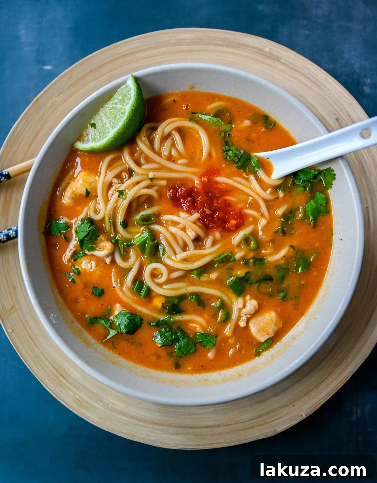 A large pot filled with Chicken Curry Noodle Soup simmering on a stovetop. The rich, creamy broth, chicken, and noodles are visible, indicating the final stages of cooking for a delicious and comforting meal.