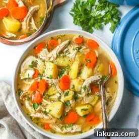 This Homemade Chicken Soup is made with tender chicken, carrots, onion, potatoes, fresh herbs, and seasonings all in a warm chicken broth. This is the perfect chicken soup on a cold winter's day. 
