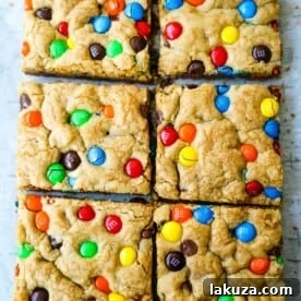 M & M Cookie Bars Soft chewy brown sugar M & M blondie cookie bars. The best M & M Cookie Bars recipe! www.modernhoney.com #bars #dessertbars #chocolatechipcookiebars
