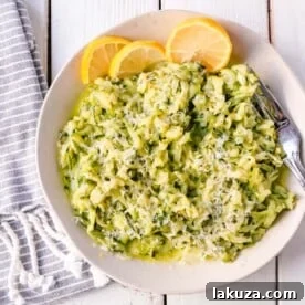 Shredded Sautéed Zucchini with Parmesan. Simple shredded fresh zucchini sauteed until tender and topped with salt, pepper, garlic, and parmesan cheese. This zucchini recipe pairs so well with beef and chicken. #zucchini #sidedish #vegetables