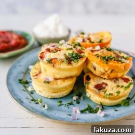 Mini Egg Bacon and Cheese Bites A quick and easy bite-size high-protein and low-carb breakfast. These mini egg bites are the perfect start for your day! www.modernhoney.com #eggbites #eggbaconbites #breakfast