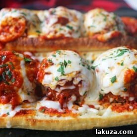 Italian Meatball Subs. Homemade beef parmesan meatballs in a fresh marinara sauce topped with melted mozzarella cheese all on toasted bread. The best meatball sub recipe! www.modernhoney.com #meatballs #meatball #meatballsub