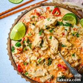 This tender Poached Coconut Milk Chicken with aromatics, creamy coconut milk, red Thai curry paste, and spices all atop rice is made in less than 30 minutes and is perfect for a weeknight dinner.