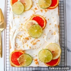 Citrus Sheet Cake with fresh orange, lemon, and lime juices, topped with cream cheese frosting and citrus slices.