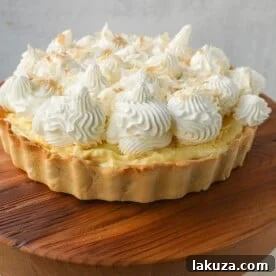 Easy Homemade Coconut Cream Pie with pudding mix, sweetened condensed milk, whole milk, whipped cream, and shredded coconut in a buttery pie crust.