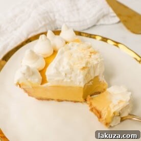 Creamy Passion Fruit Pie topped with fresh whipped cream, a tropical cream pie similar to key lime pie but made with passion fruit.