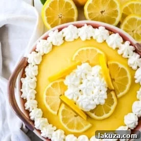 A simple creamy lemon cream pie with fresh lemon zest in a buttery graham cracker crust with sweetened whipped cream.