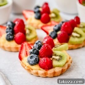 French Fruit Tart with a flaky, buttery pie crust, homemade vanilla bean pastry cream, and fresh fruit topping.