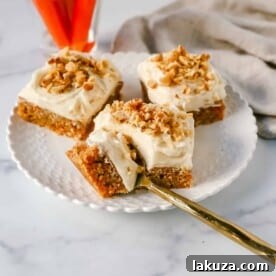 Soft, chewy carrot cake bars with cream cheese frosting, tasting even better than carrot cake itself.