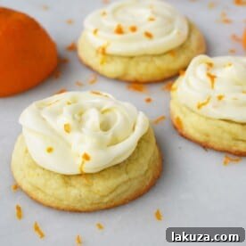 Soft citrus orange dough cookies topped with sweet orange zest cream cheese frosting.