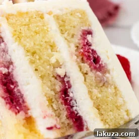 Light and fluffy lemon cake with fresh raspberries and a lemon cream cheese frosting.