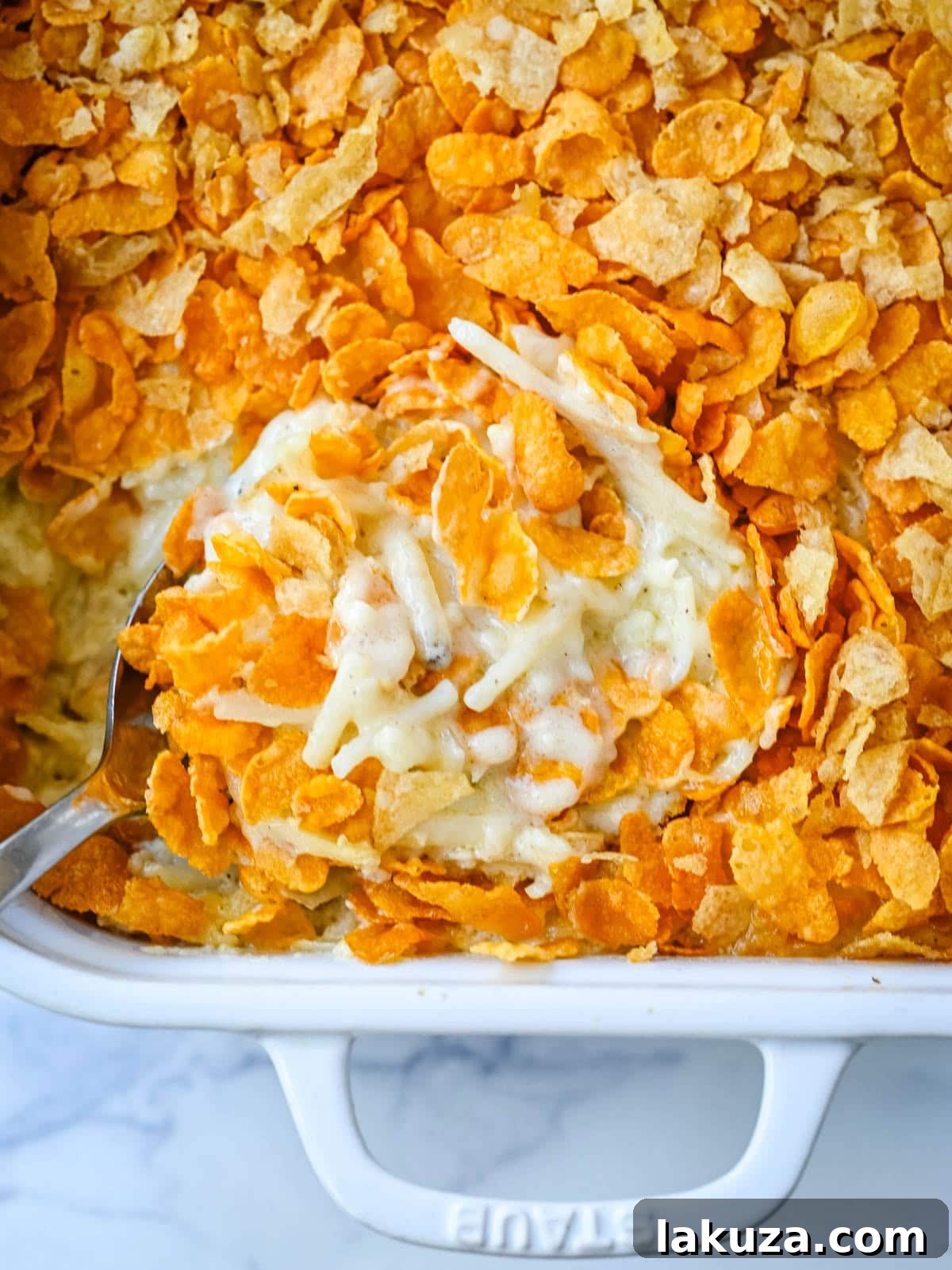 Hearty Cheesy Potato Casserole 2 A close-up shot of creamy, cheesy Funeral Potatoes with a golden, crispy topping, perfect for serving at a family gathering.