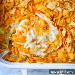 Creamy and cheesy Funeral Potatoes, a classic comfort food side dish, served in a white dish.