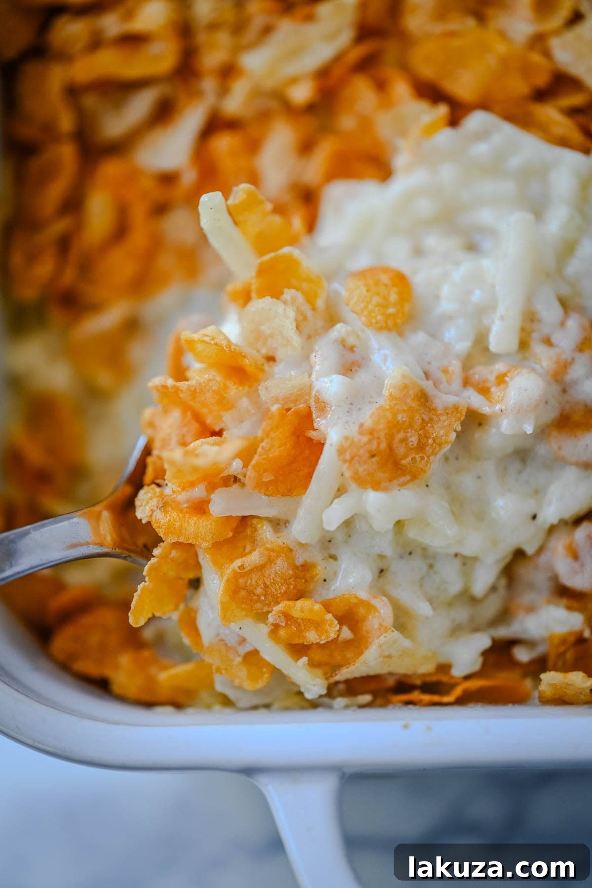 Hearty Cheesy Potato Casserole 6 The finished Funeral Potatoes casserole, fresh from the oven, with a perfectly browned and crunchy cornflake and potato chip topping.