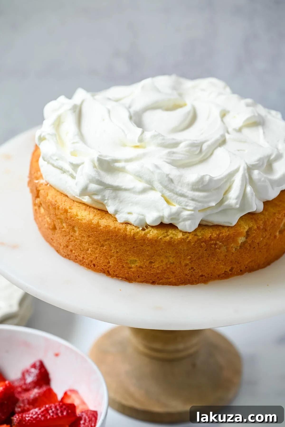 Fresh Strawberry Shortcake Delight 7 Spread whipped cream all over cake