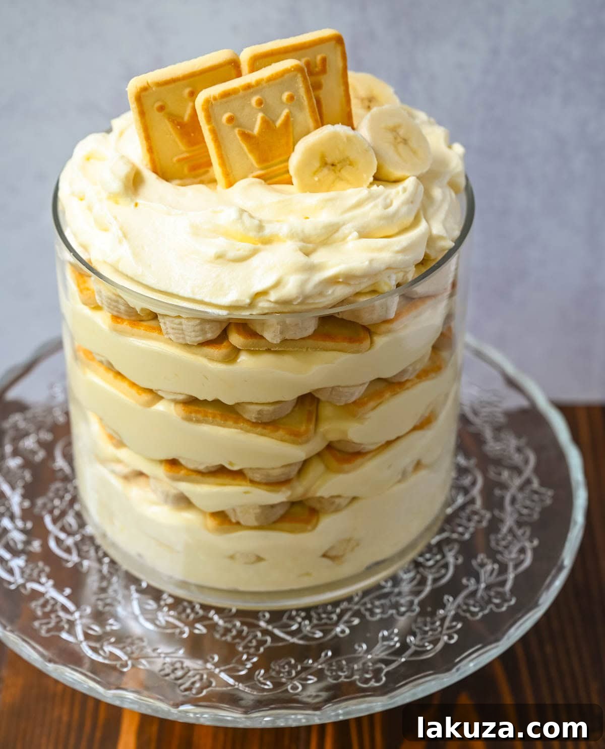A large serving of banana pudding with Chessmen cookies in a glass dish, ready to be served.