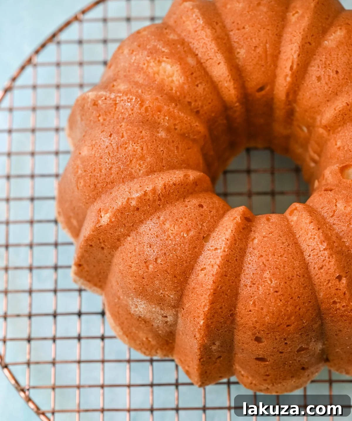 Close-up of a slice of moist sour cream pound cake, showing its tender crumb and rich, golden color.