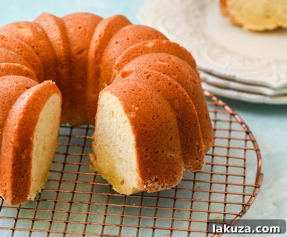 Ingredients for sour cream pound cake laid out, including butter, eggs, flour, and sour cream.