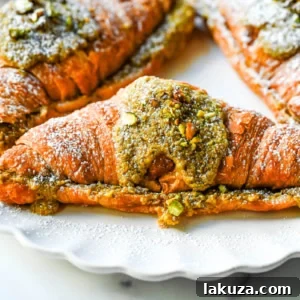 Make your own Pistachio Croissants at home in just a few easy steps! Buttery croissants are stuffed with a creamy pistachio cream filling and topped with a simple syrup and chopped pistachios for crunch. The easiest Pistachio Croissant recipe made in less than 30 minutes!