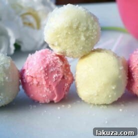 Delicious Strawberry Recipes for Every Occasion 15 Strawberry cheesecake truffle cake pops rolled in white candy coating.