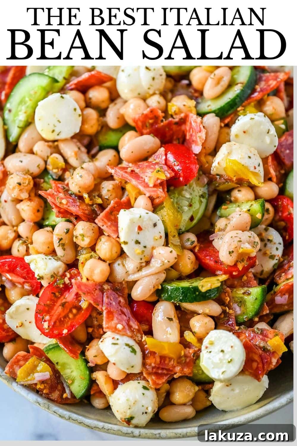 This Italian dense bean salad is the TikTok viral high protein meal prep recipe that has taken over the internet and for very good reason. Loaded with chickpeas, white beans, crisp Persian cucumbers, cherry tomatoes, creamy mozzarella, savory pepperoni or salami, and tangy pepperoncinis all tossed in a homemade Italian dressing, every single bite is packed with incredible flavor that gets better the longer it sits.