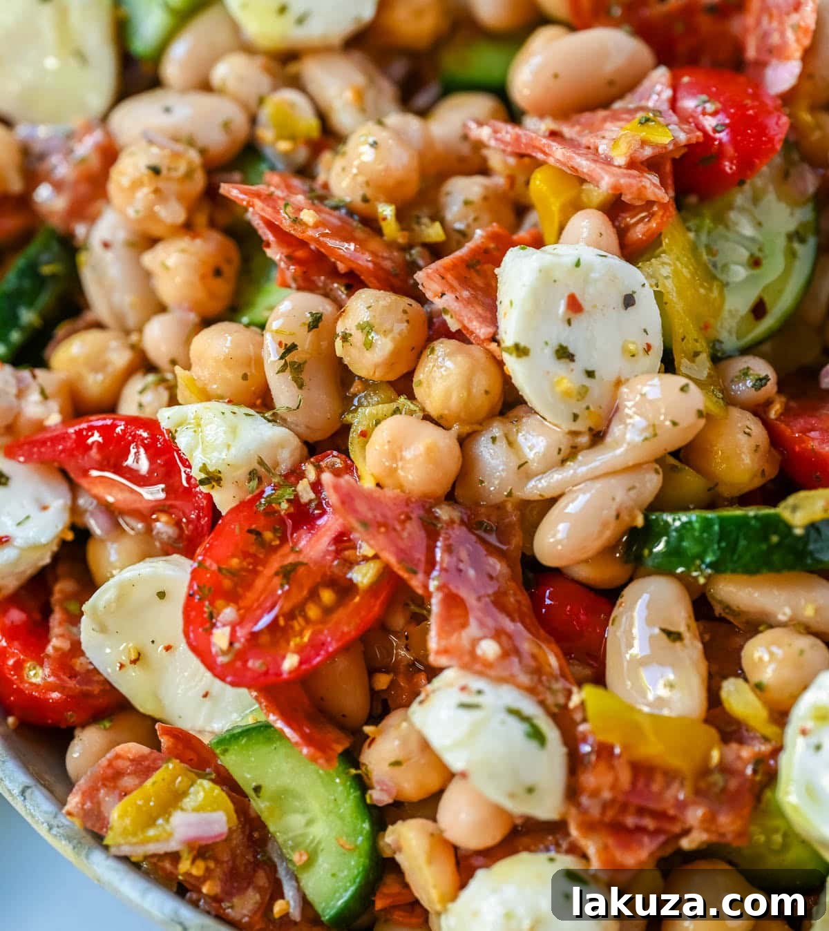 This Italian dense bean salad is the TikTok viral high protein meal prep recipe that has taken over the internet and for very good reason. Loaded with chickpeas, white beans, crisp Persian cucumbers, cherry tomatoes, creamy mozzarella, savory pepperoni or salami, and tangy pepperoncinis all tossed in a homemade Italian dressing, every single bite is packed with incredible flavor that gets better the longer it sits.
